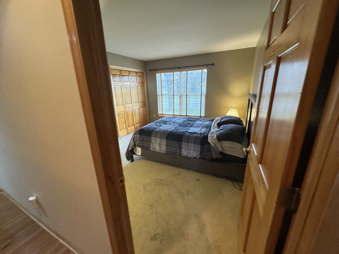 Bedroom with original carpet and window treatments in Germantown, Wisconsin