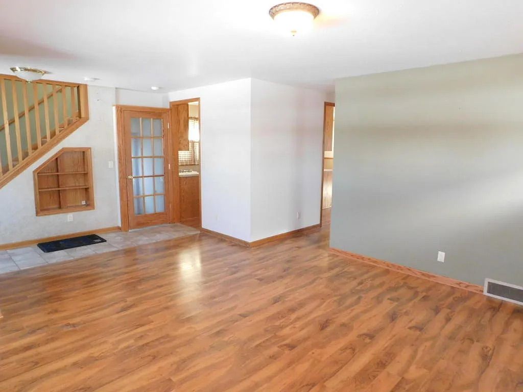 Entry and living space with refinished flooring in the Milwaukee converted duplex