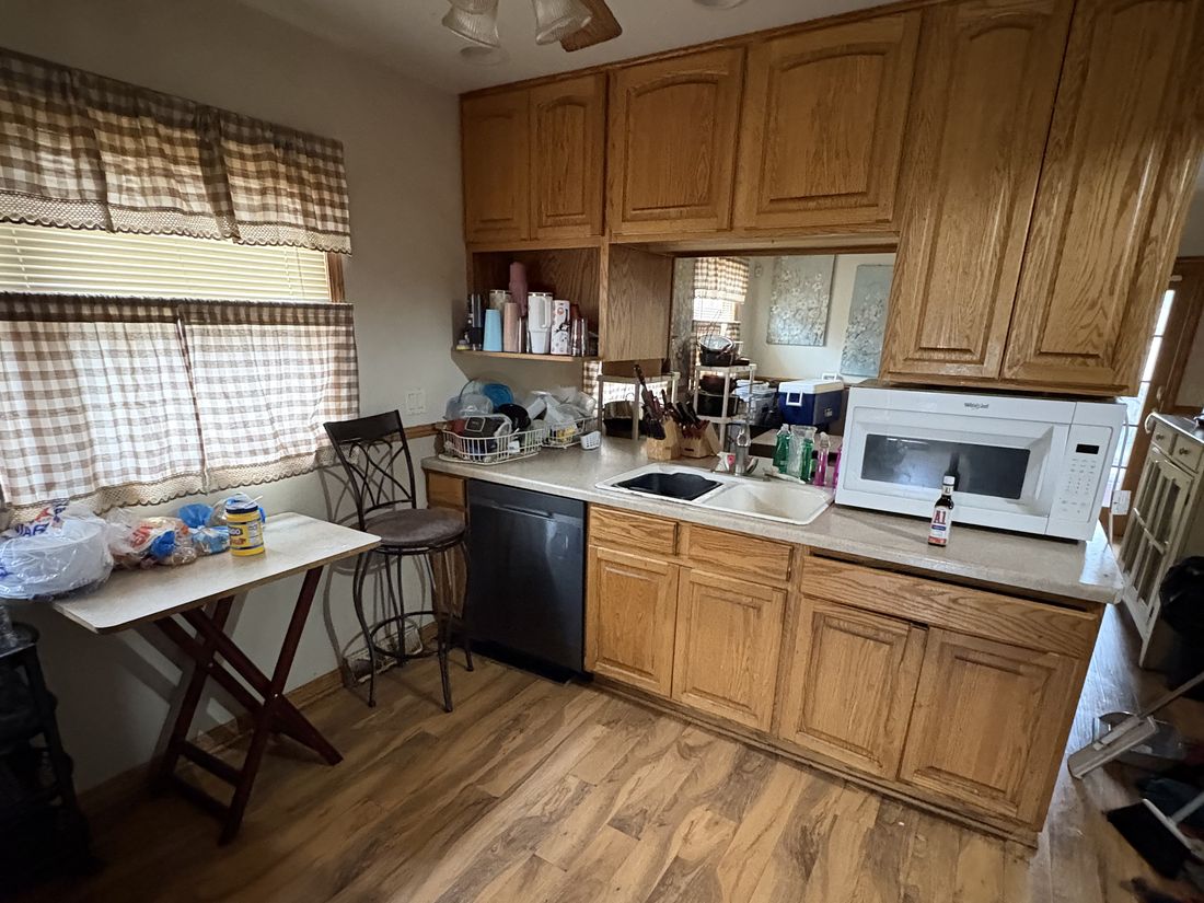 Original oak kitchen showing cosmetic wear in the Milwaukee, WI home before renovation