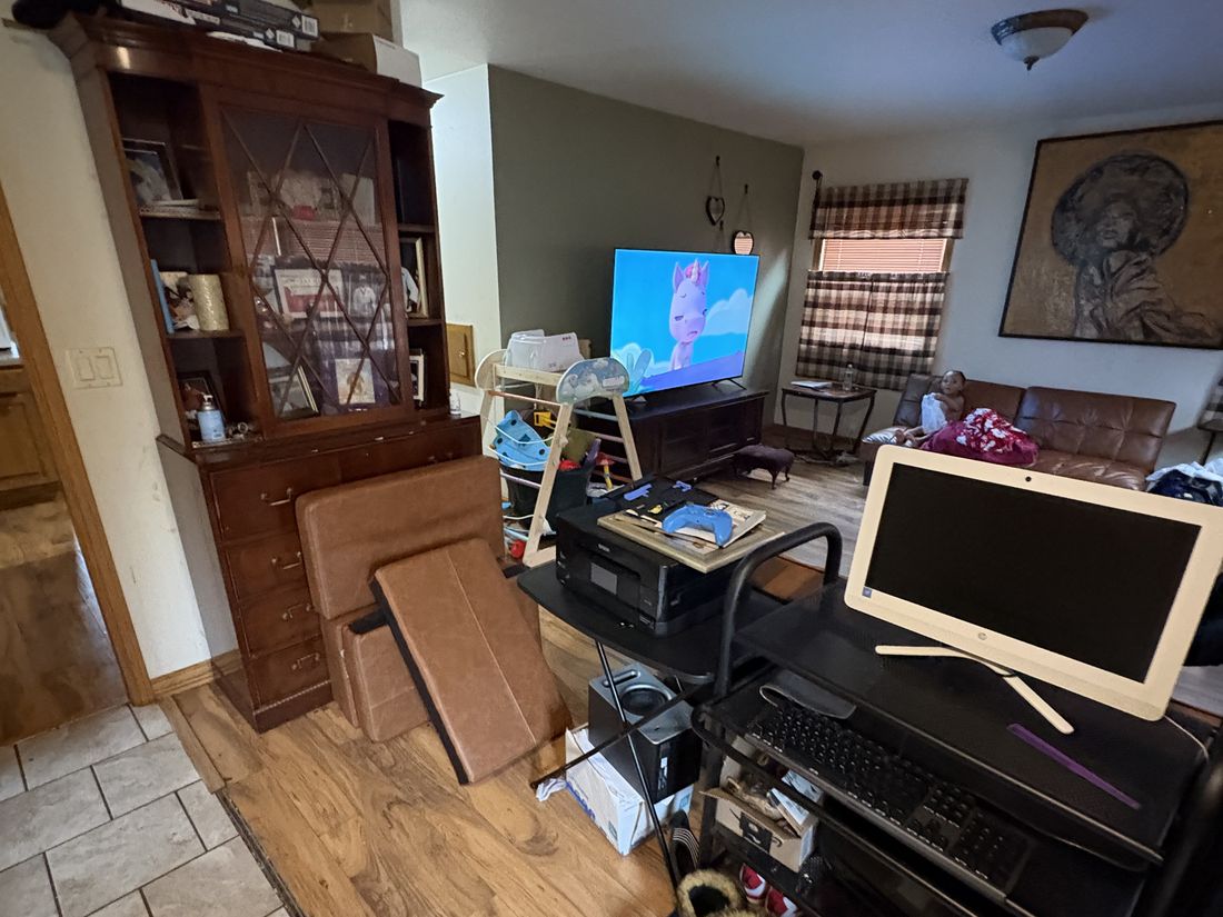 Living area of the Milwaukee converted duplex, occupied and full of belongings before the sale