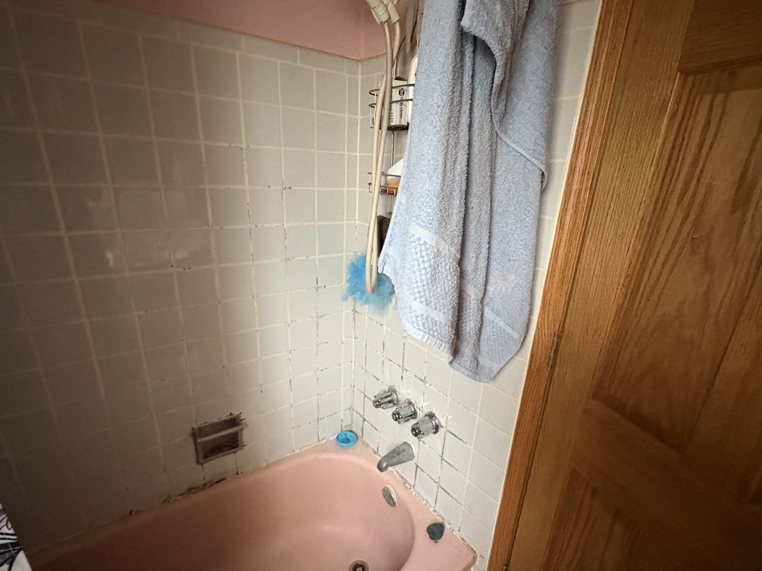 Original pink bathroom suite with tub in the Milwaukee, WI home before updating