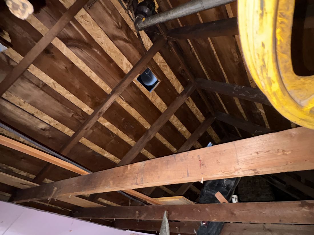 Collapsed ceiling from a radiator leak in the lower unit of a West Allis, WI duplex