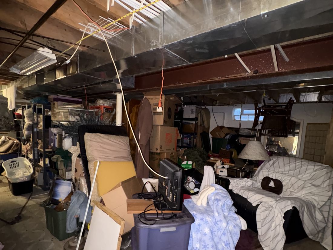 Basement filled with decades of accumulated storage in the West Allis estate property