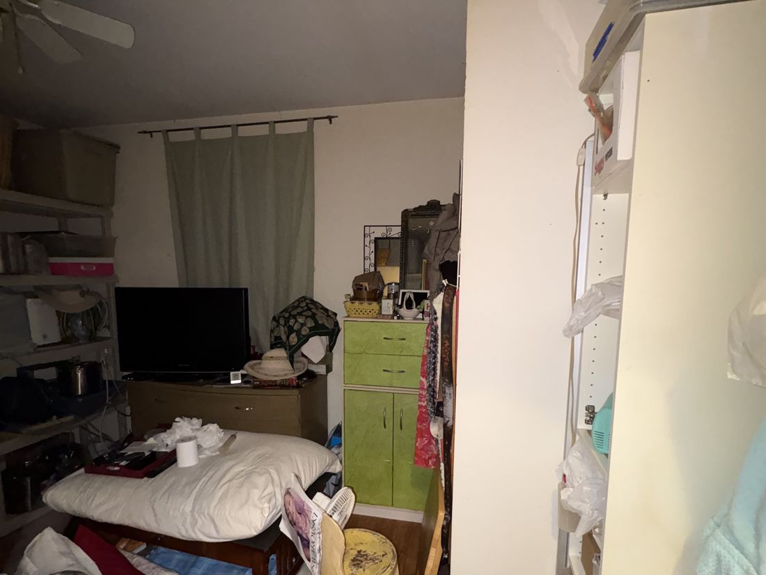 Room filled with belongings left behind in the vacant West Allis, WI property