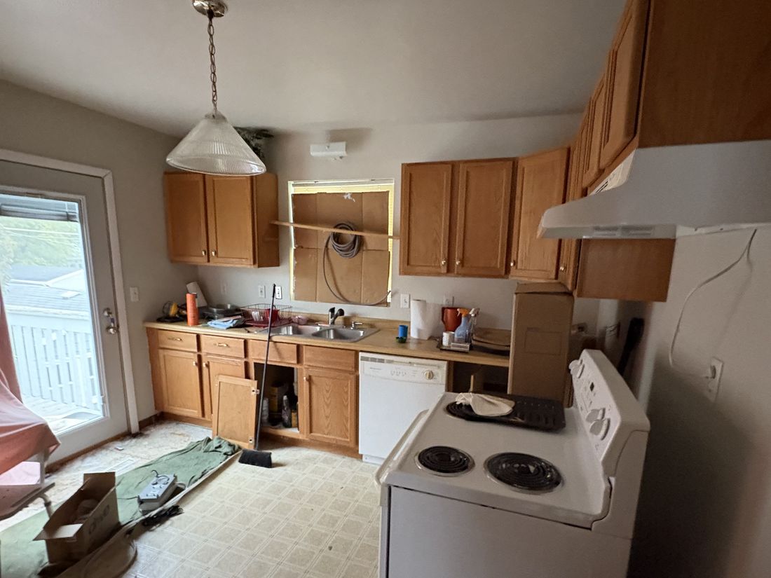 Upper-unit kitchen with original oak cabinetry in the West Allis estate duplex